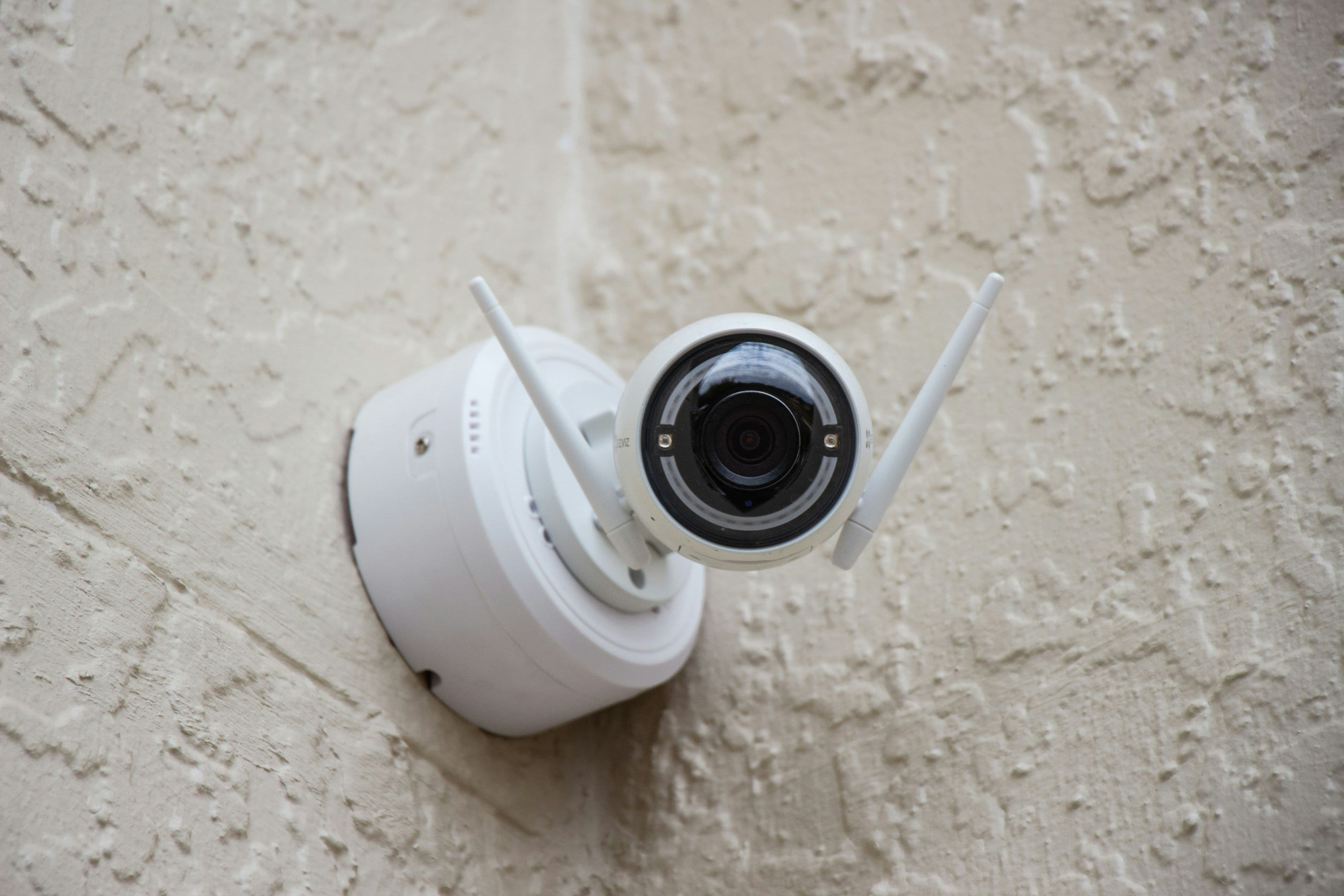A small Wi-Fi security camera mounted on an exterior wall