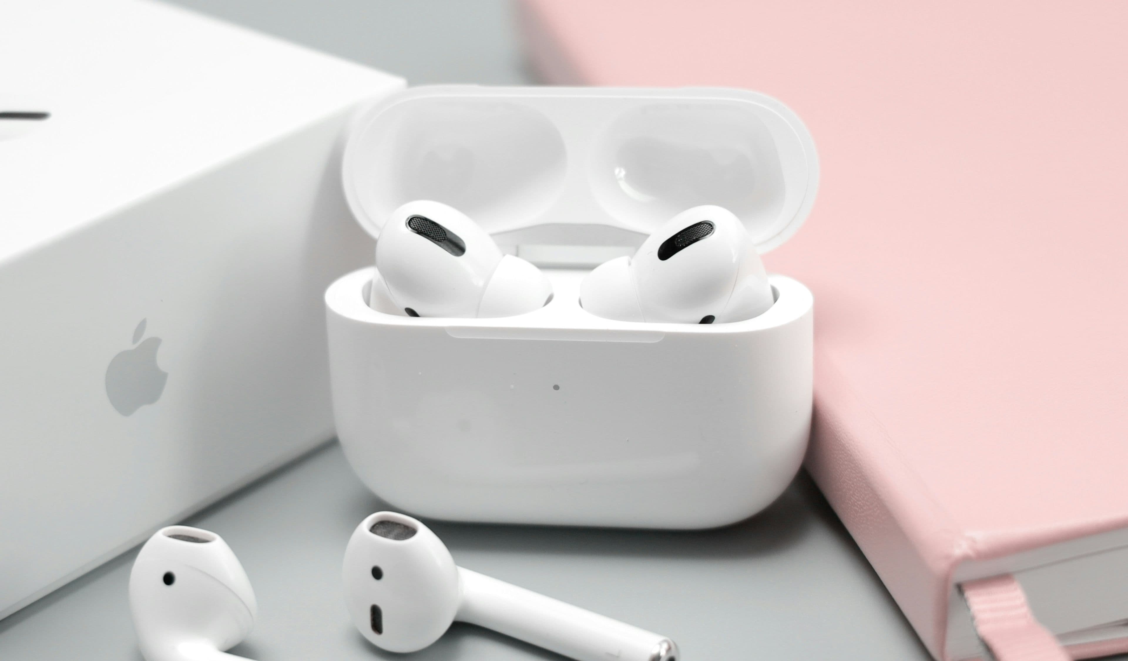 A pair of budget wireless earbuds resting in their open charging case