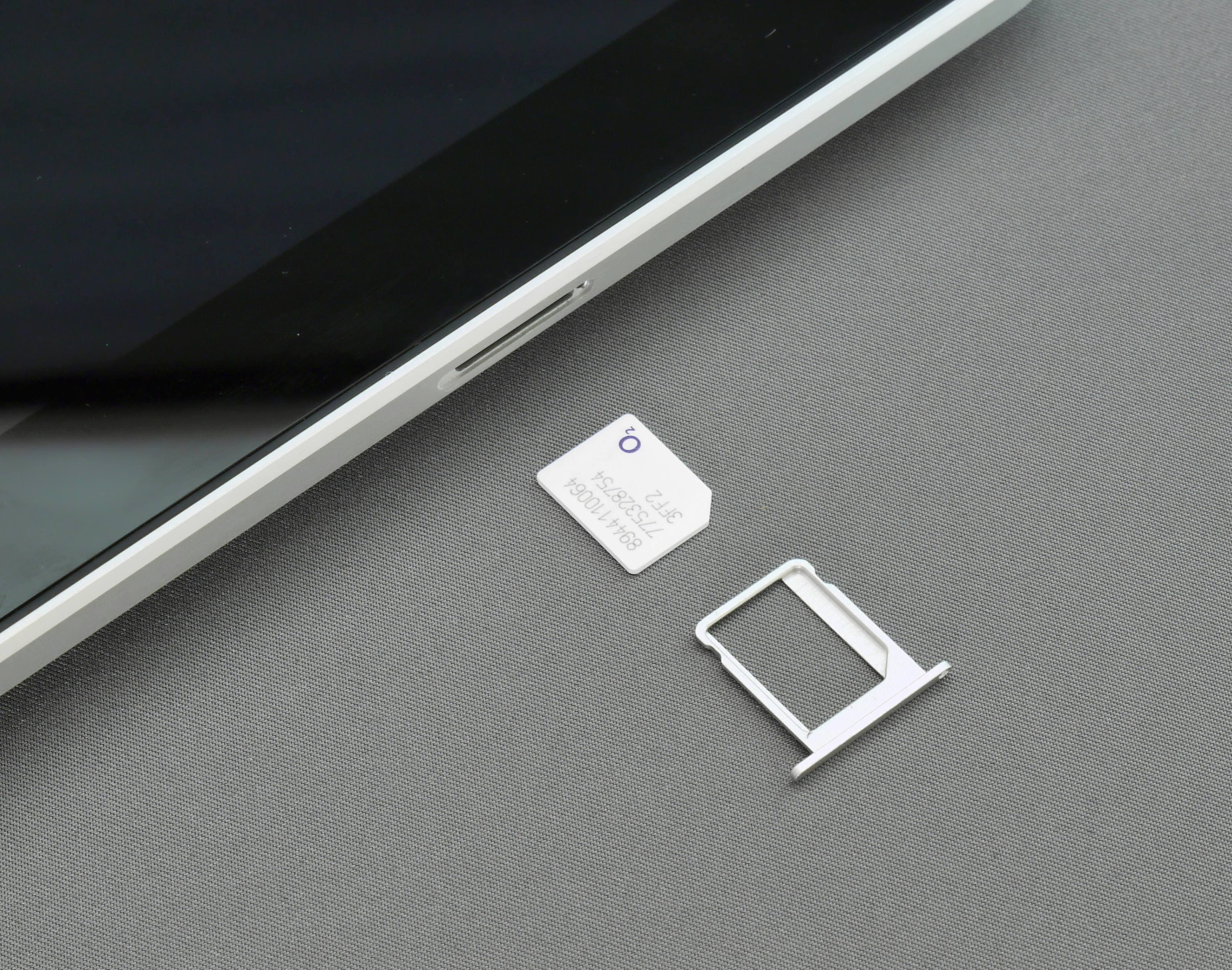 A smartphone with its back cover off showing a dual-SIM tray